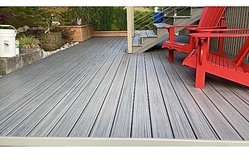 Grey composite deck with red Adirondack chairs