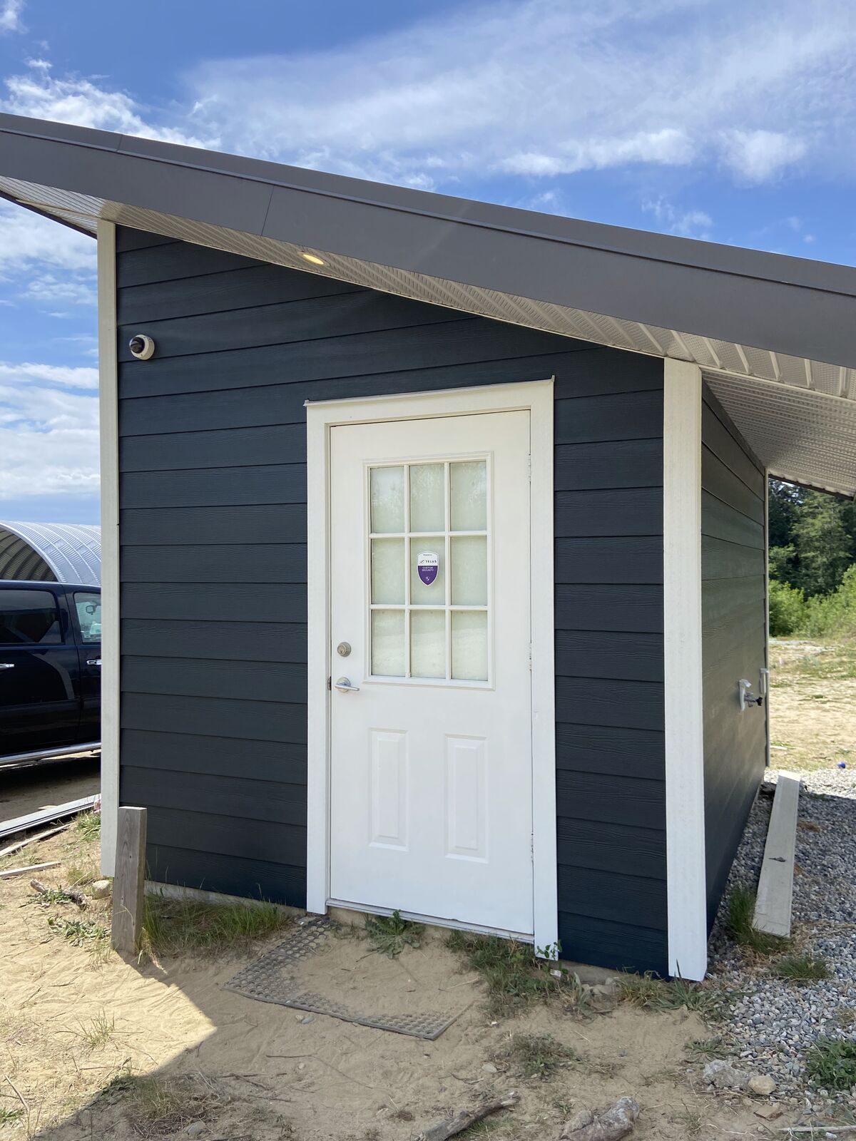 Front of a finished bunkie with white door