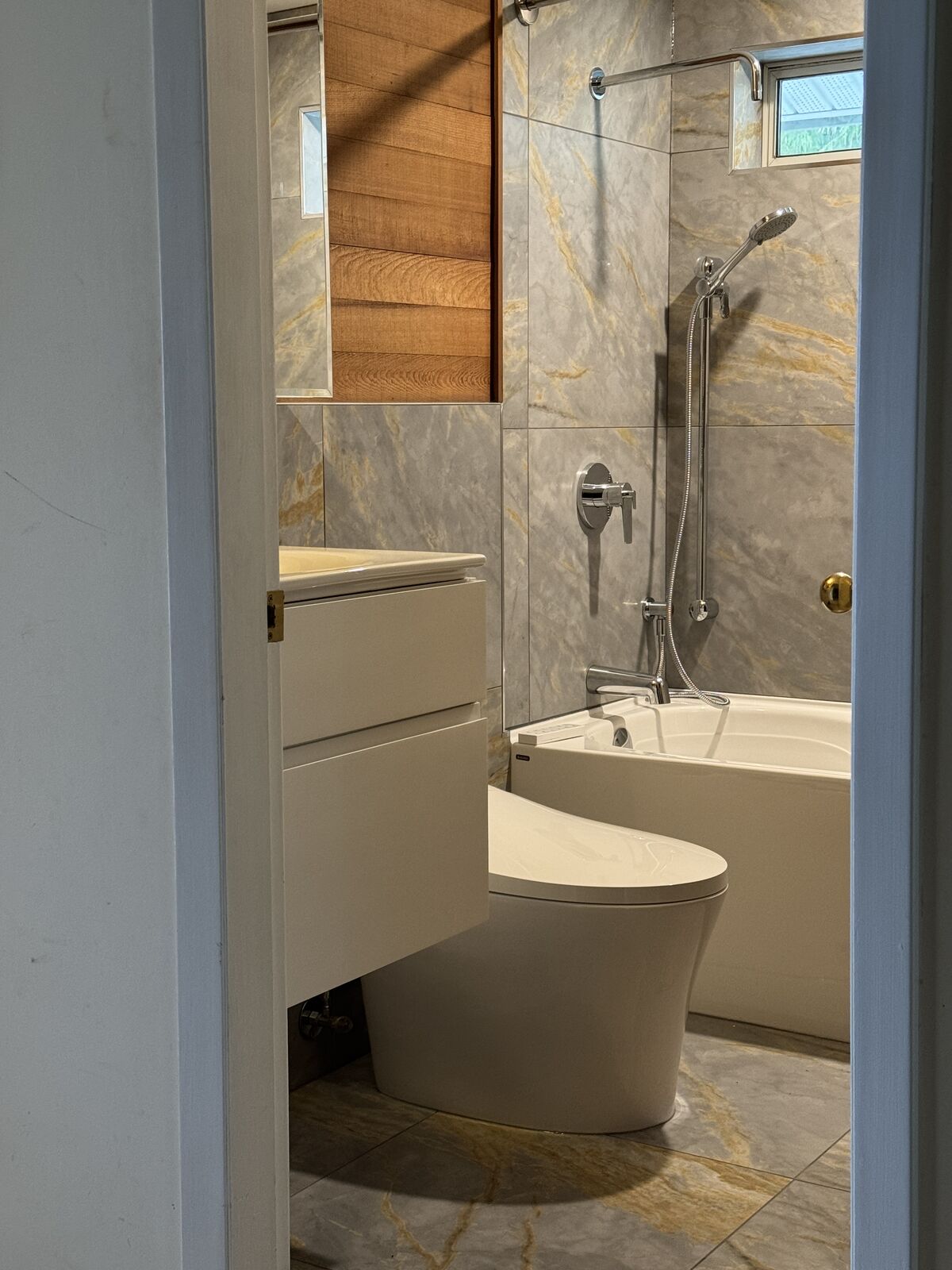 Renovated bathroom with floating vanity and tiled shower